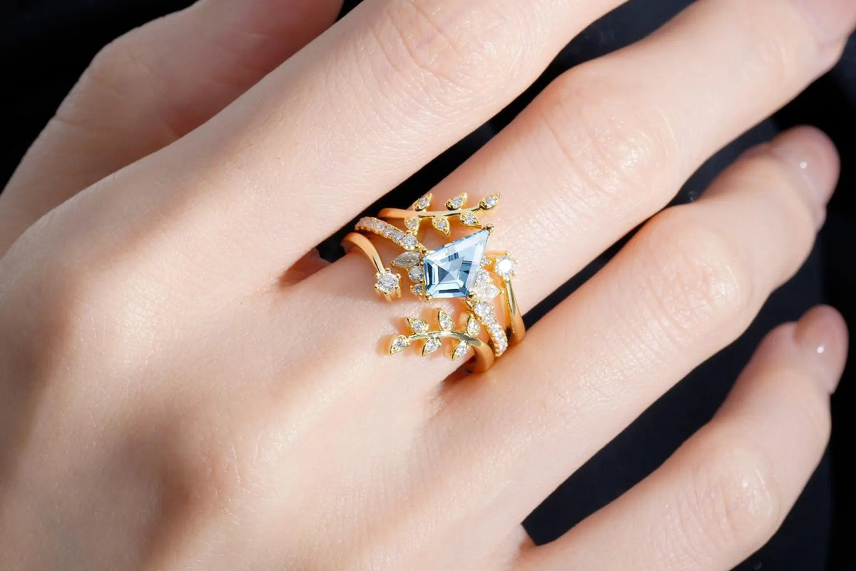Clorosea kite-cut aquamarine engagement ring set worn on a hand